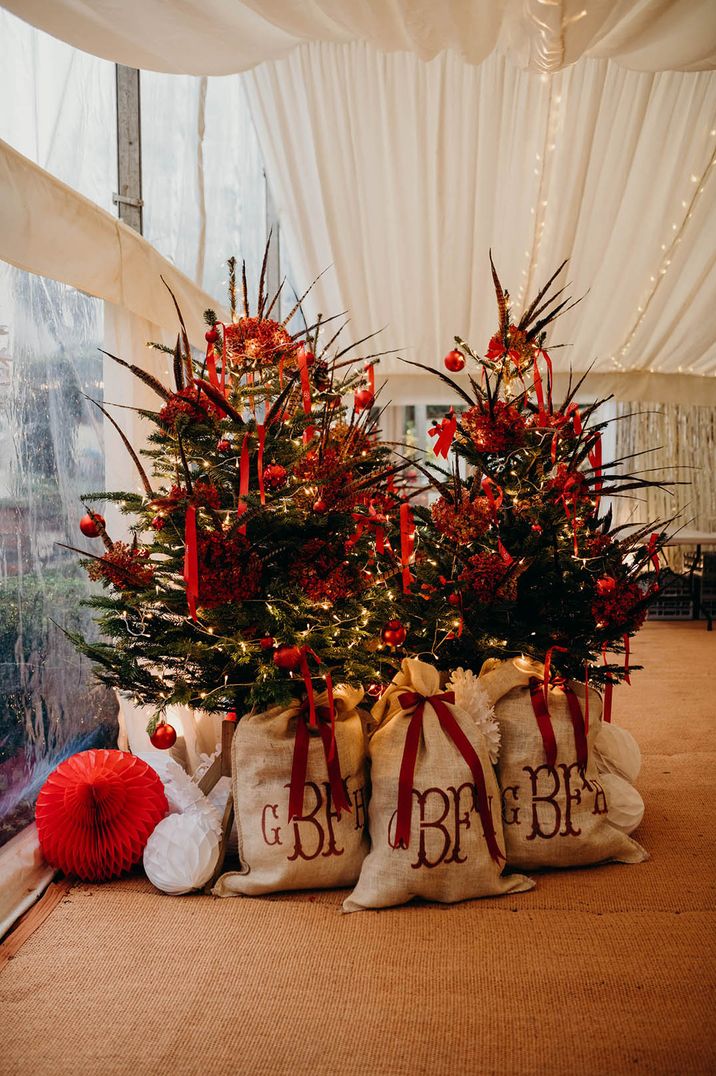 Christmas trees with presents and sacks from Santa at Christmas wedding 