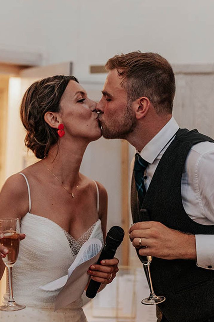 The bride and groom share a romantic kiss after their speech together 