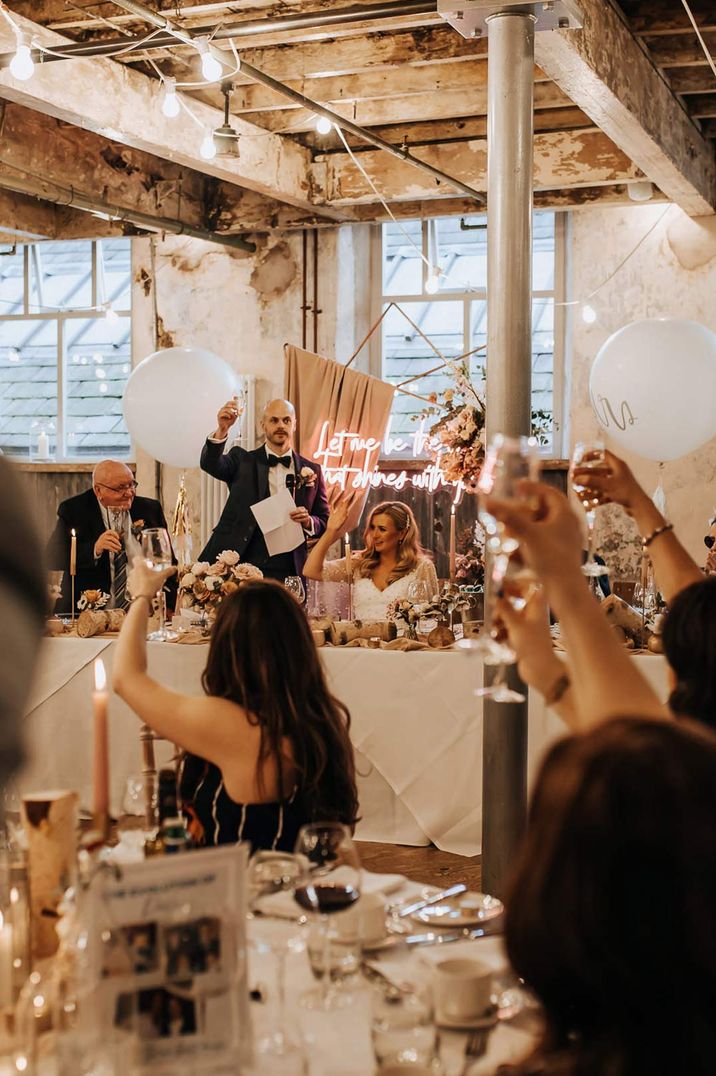 Pink neon wedding sign at Holmes Mill wedding venue with large white balloons 