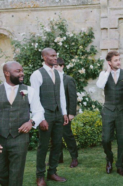 The groomsmen in green and white wedding suits getting ready for a wedding 