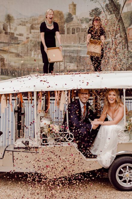 Couple in cream Tuk Tuk wedding transport with colourful confetti