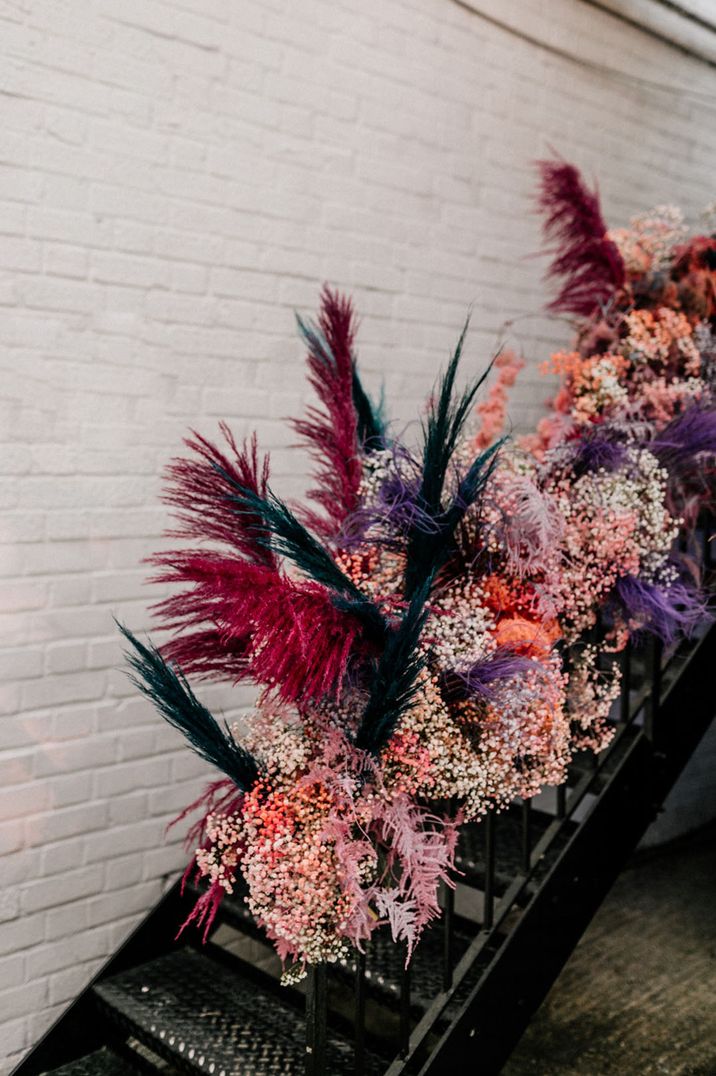 Dyed pink, purple and blue pampas grass with gypsophila decoration for the staircase 