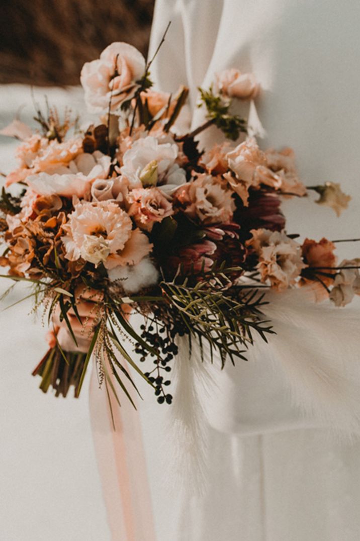 Neutral blush pink wedding bouquet with carnations and king proteas 