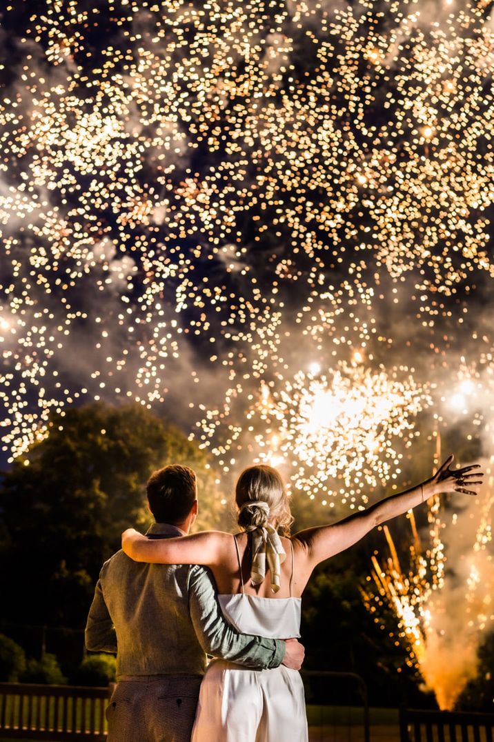 bride and groom after their wedding a Sefton Park Palm House celebrating the end of the evening with a firework display 