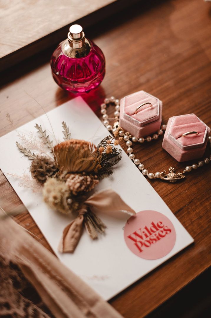 Bridal accessories with dried flowers, pink perfume bottle and jewellery 