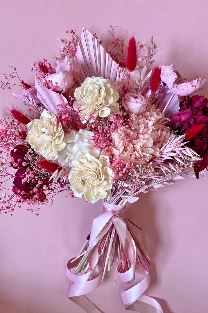 Hot pink summer wedding flower bouquet made from dried wedding flowers with dyed pink flowers and foliage 