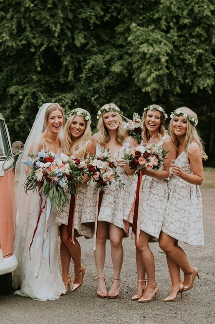 Classic orange VW camper van with bridal squad - bride in long lace wedding dress and long veil, bridesmaids in short lace bridesmaid dresses 