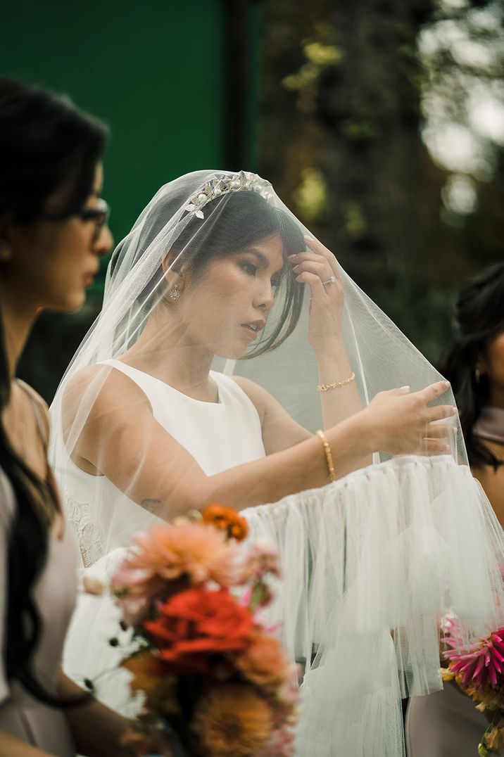 Bride wears cathedral drop veil 