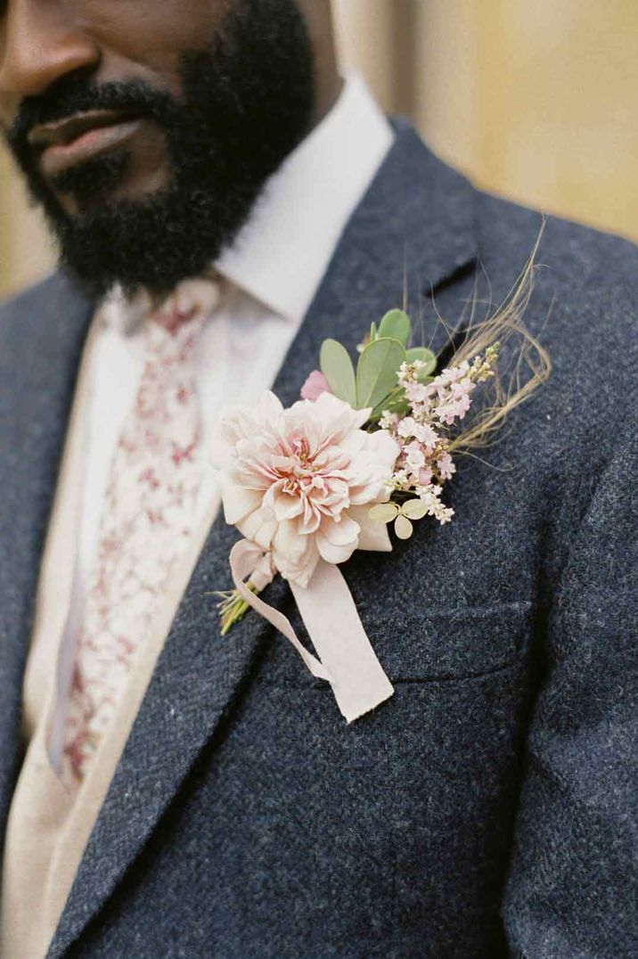 Groom in textured blue wedding suit with white shirt and pink floral wedding tie with light pink peony, baby's-breath and dried flower boutonniere - wedding budget spreadsheet 