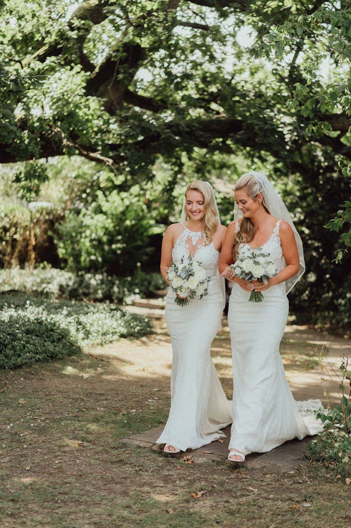 Two brides in lace wedding dress and veils at intimate Micklefield Hall wedding 