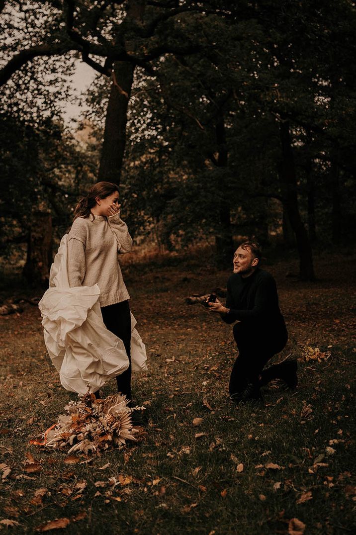 Man proposes to his partner at autumnal location 