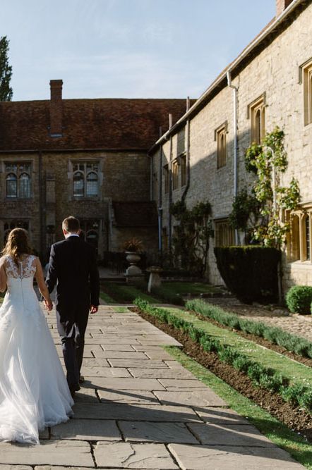 Bride and groom walking the grounds of a country house wedding venue