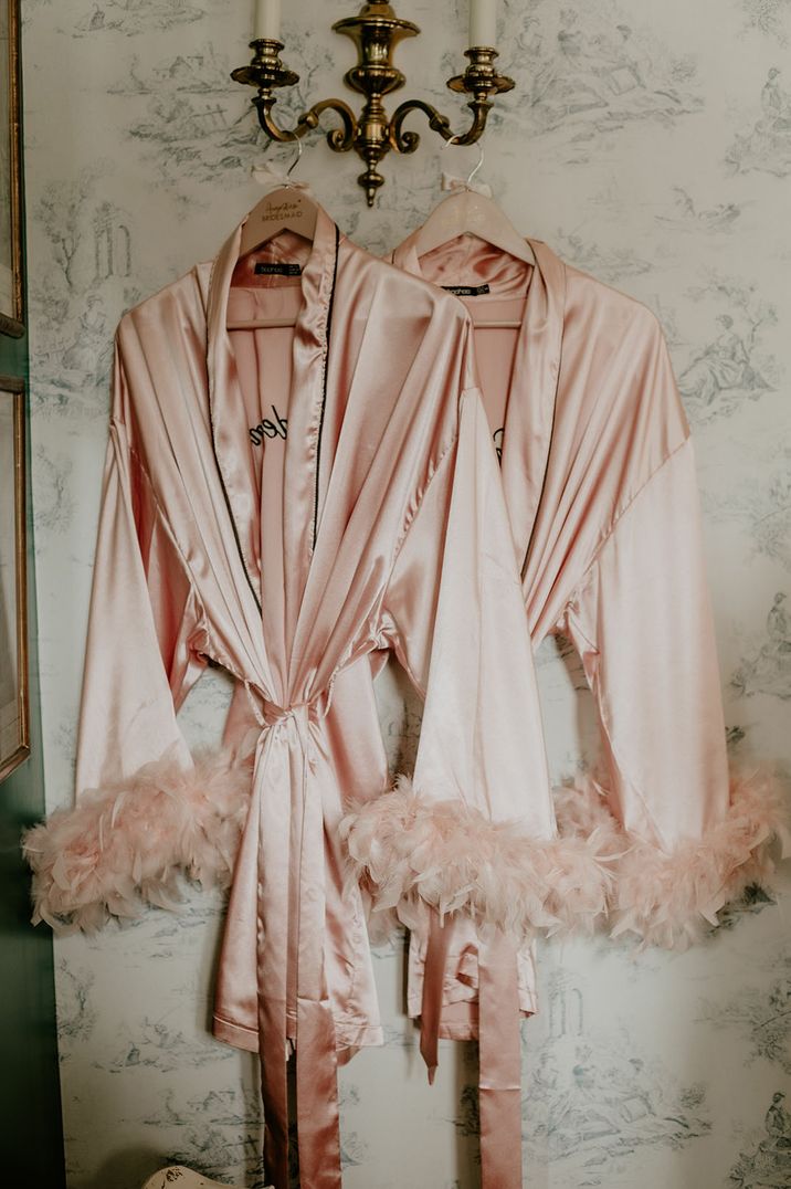 Pale pink silk robes complete with feathered edging 