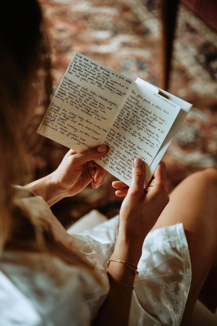 The bride reads a handwritten note gifted to her on the morning of the wedding by the groom 