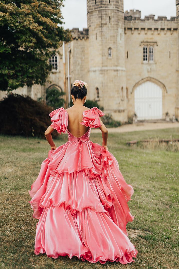 pink coloured wedding dress with waterfall style ruffles