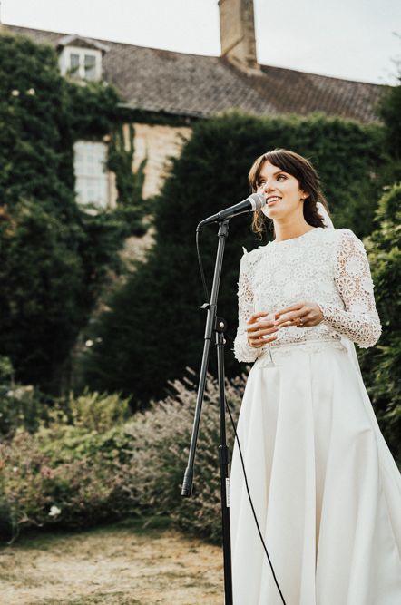 Person making wedding speech in long white dress with flower lace detail 