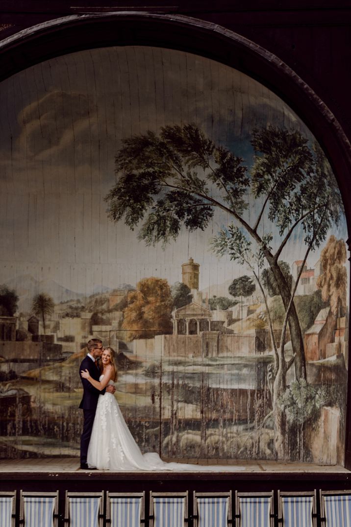 Bride in bandeau wedding dress and groom in dark suit at Larmer Tree Gardens