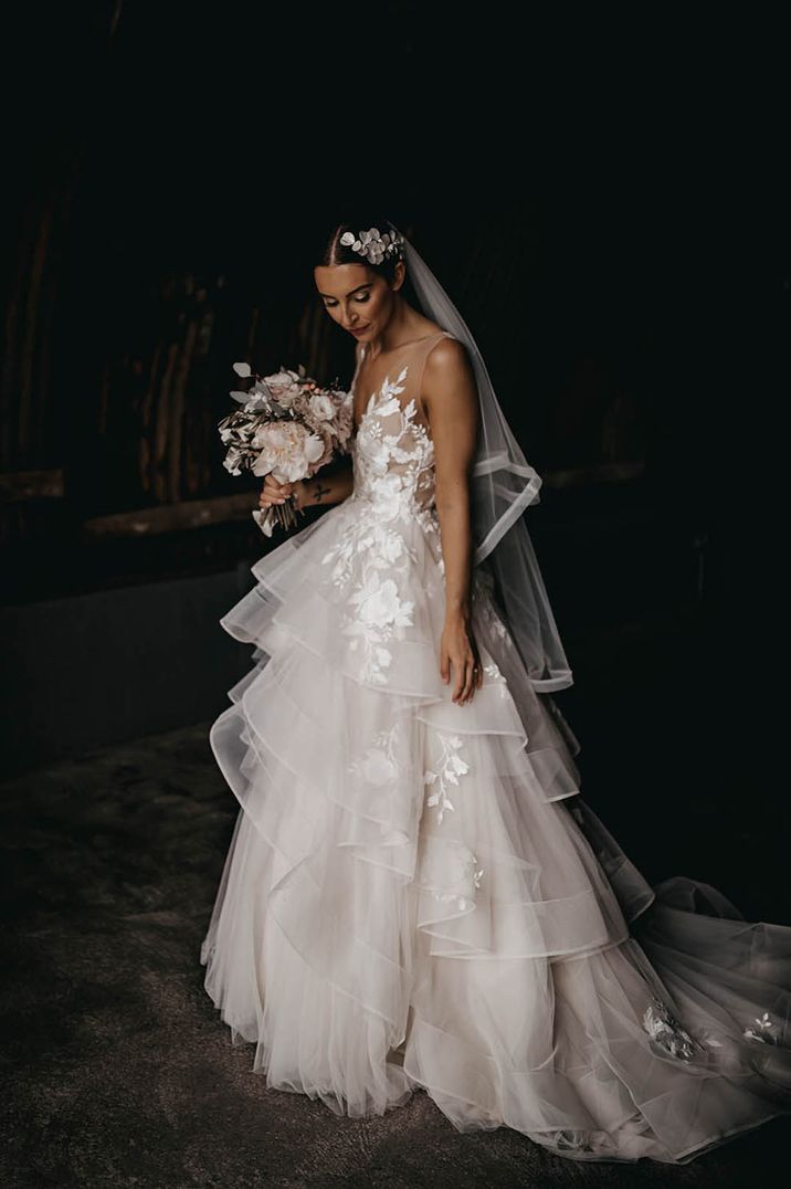 Bride in Wtoo by Watters layered ruffle wedding dress with white flower hairpiece for Devon wedding 