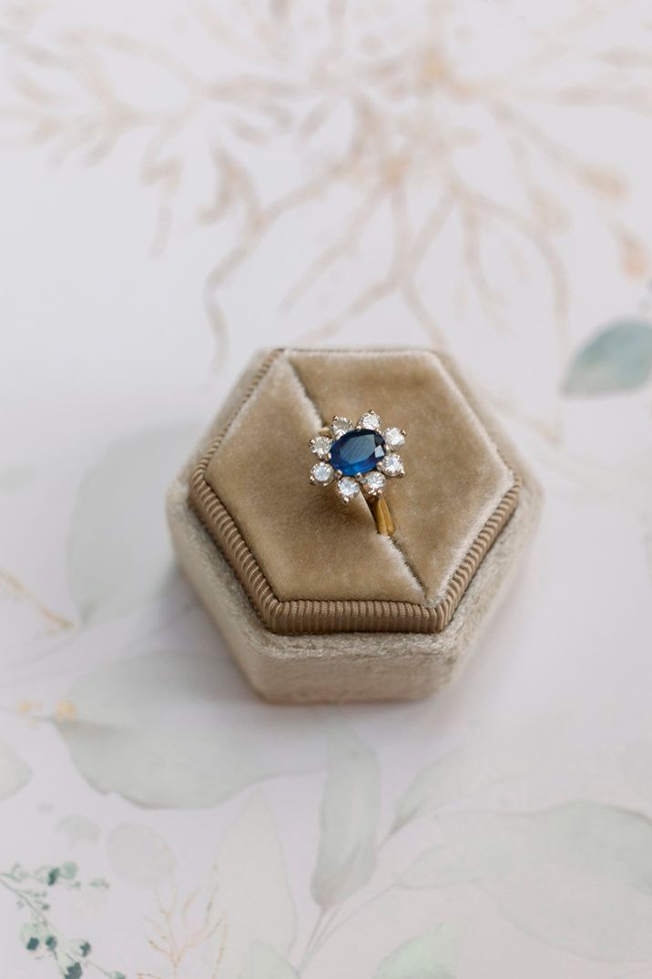 Hexagonal ring box with a sapphire engagement ring 