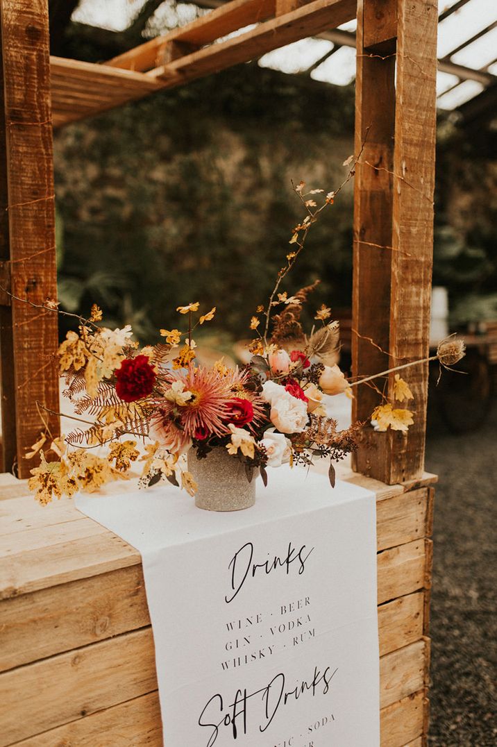 Autumnal rustic themed wedding bar design idea with dried wedding flowers and fabric menu sign 