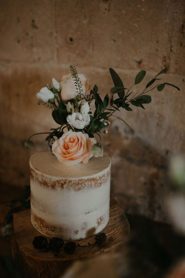 Simple single tier wedding cake with floral decor