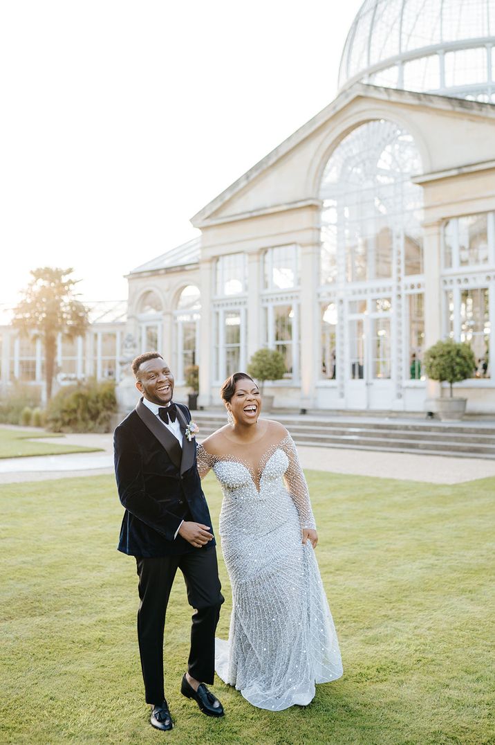 Groom in black tuxedo with the bride in sparkly wedding dress for the vow renewal 