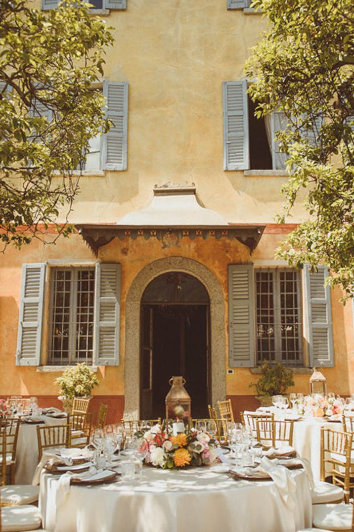 Destination wedding over 60k at Lake Como with outdoor dining and tables decorated with rustic lanterns 