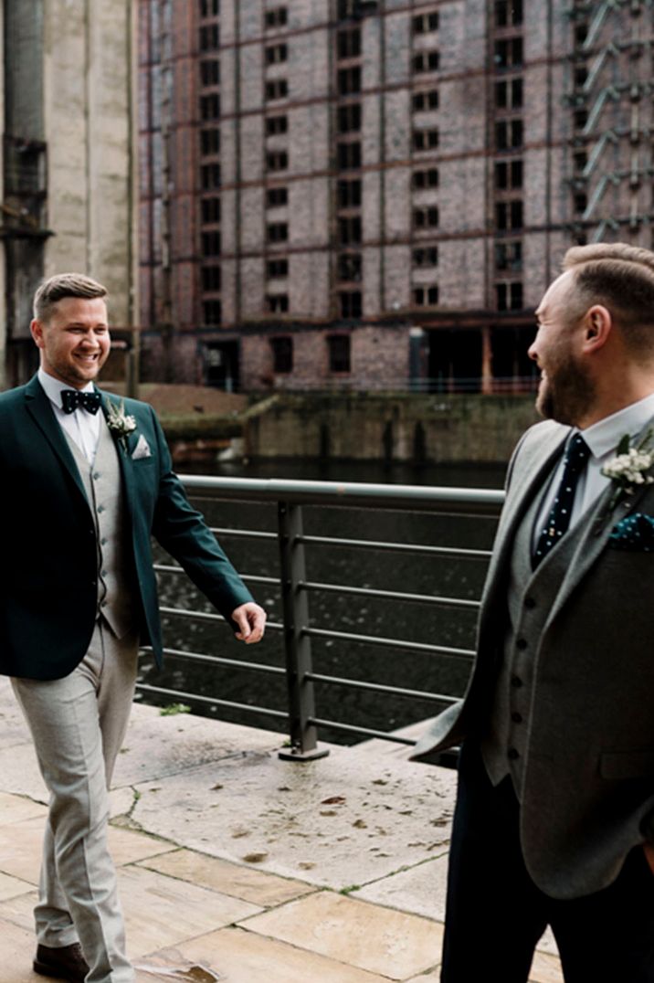 Two grooms in grey wedding suits have first look at their city wedding in Liverpool 