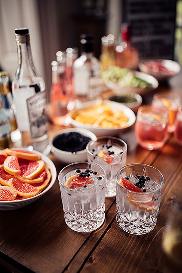 Crystal glassware with signature cocktails decorated with fruit garnishes 