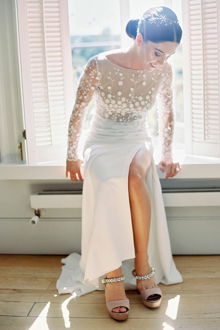 Long sleeve wedding dress with appliqué detail and front split 