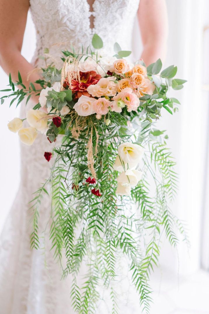 Beautiful bouquet of blush roses, carnations and wild foliage at LGBTQI+ wedding