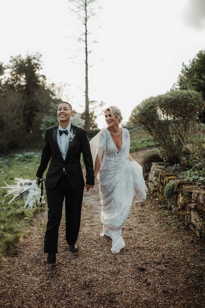 non-binary wedding with silver sparkly wedding dress and black tuxedo