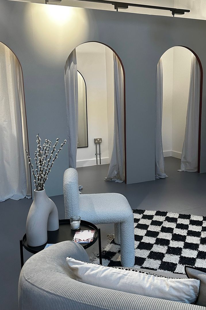 The changing rooms at Rewritten Bridesmaids Studio in London with cosy seating 