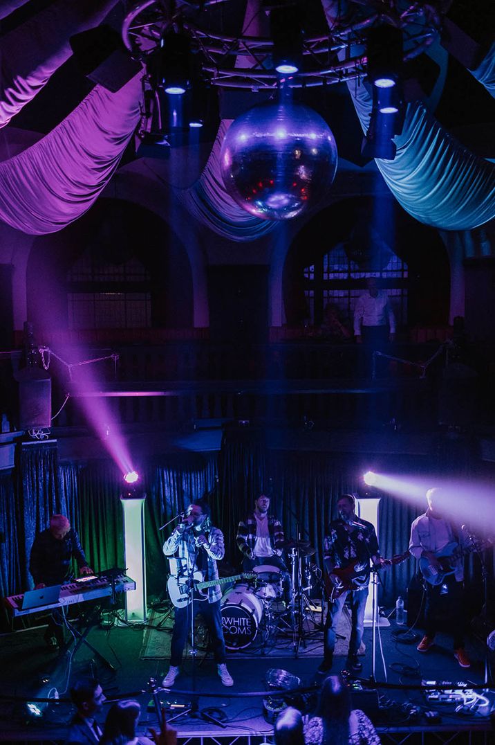 Colourful purple and blue lighting at wedding reception with live band and music 