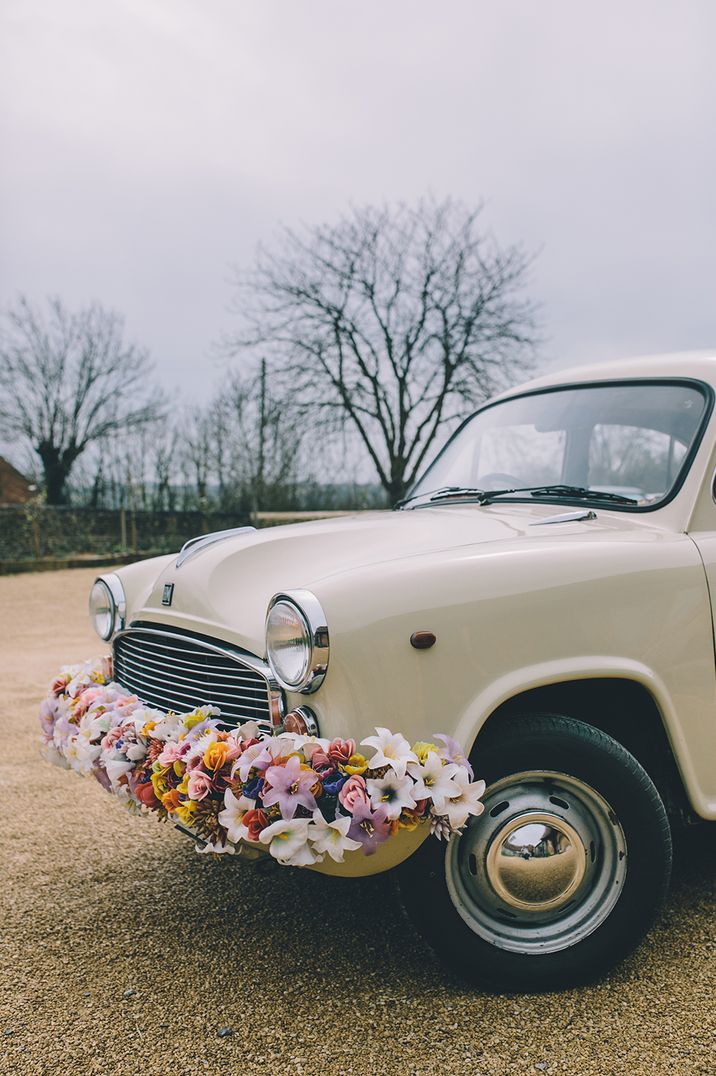 Classic wedding car with floral bumper decoration