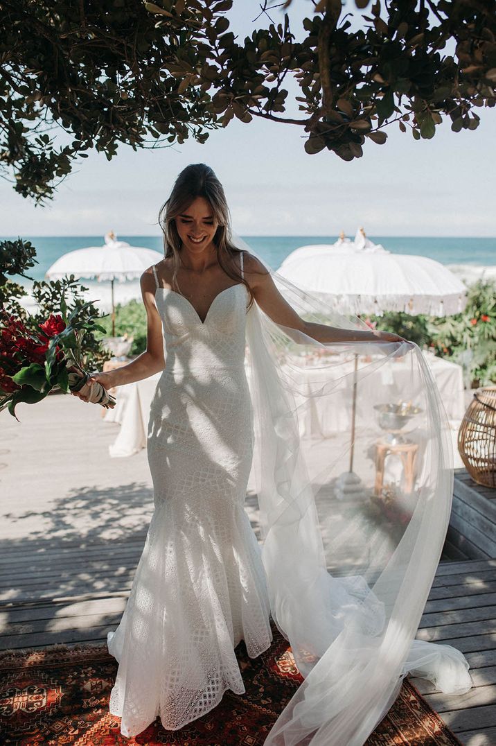 Destination wedding with the bride in a beach lace gown and a mermaid style