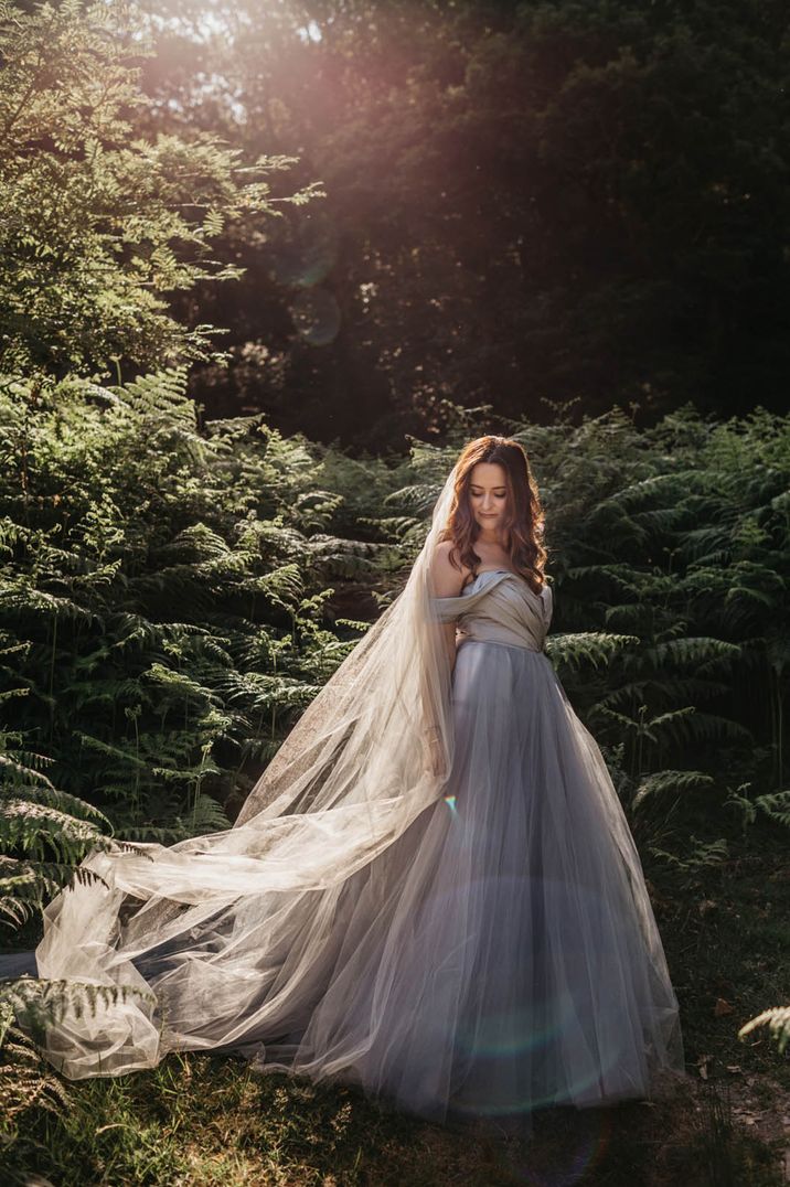 Bride in tulle blue strapless wedding dress and matching veil for Irish wedding 