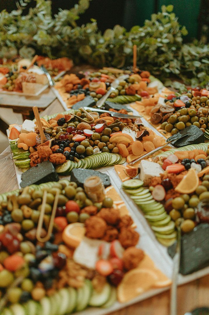 Vegan grazing board inspiration with dried fruits and pots of honey 