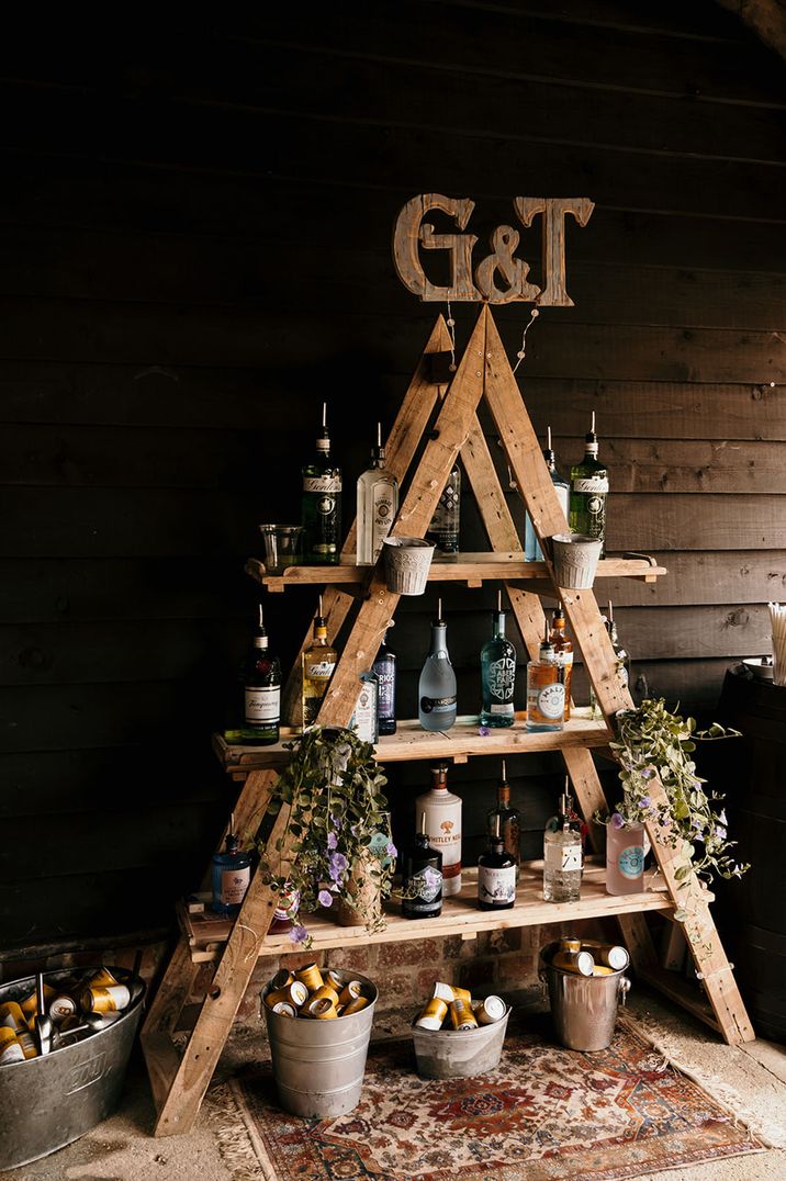 DIY G&T bar design with different brands of gin on shelves with pour spouts 