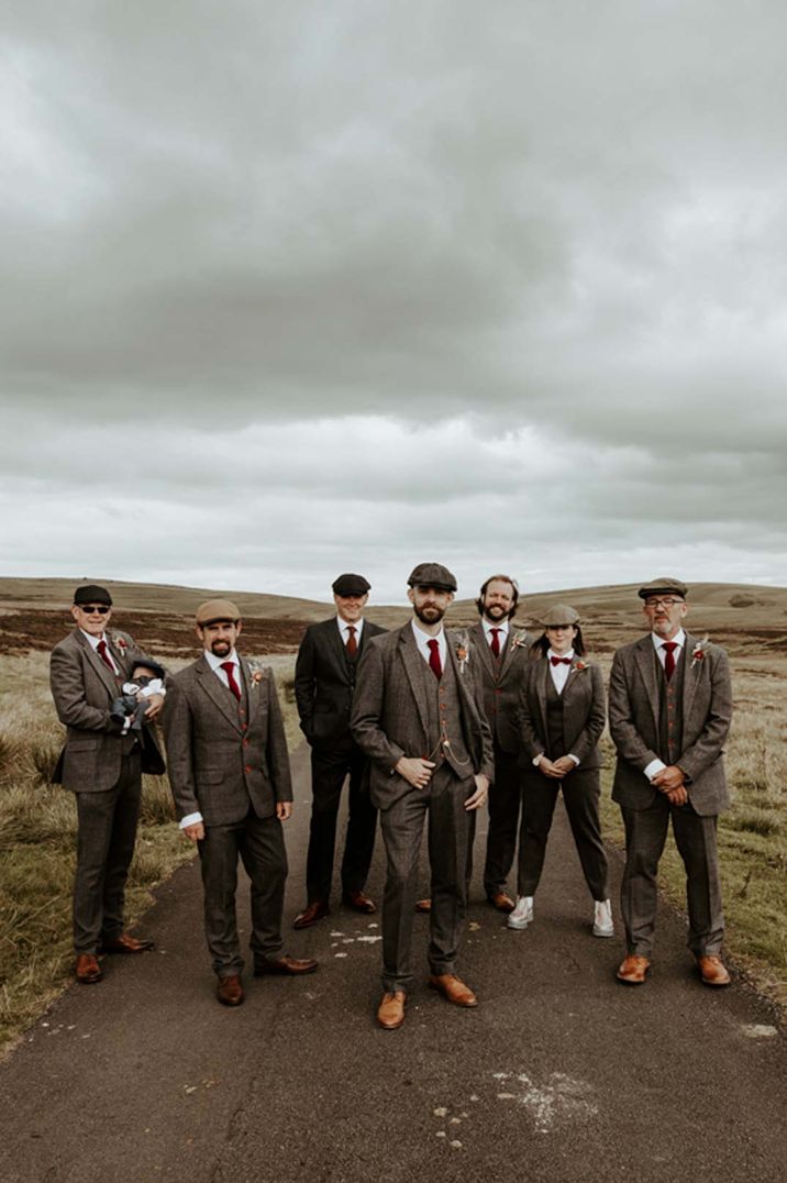 Mixed gender wedding party with groomswoman in tweed suits and red ties at Eden Barn wedding