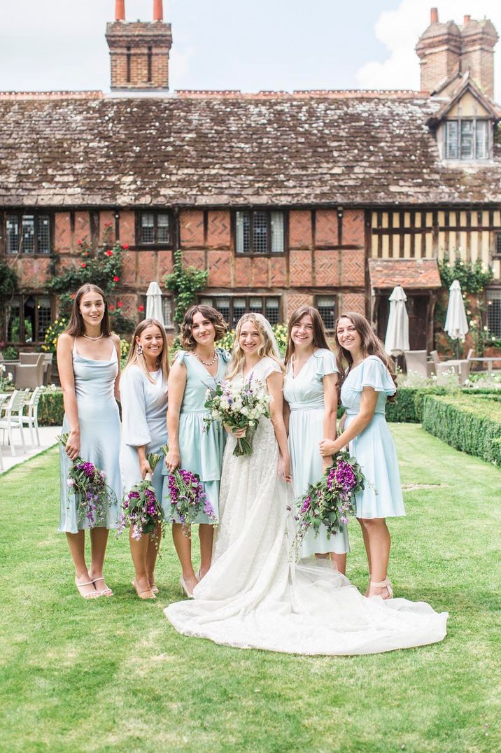 Bridal party wearing mint green bridesmaid dresses with the bride in a lace wedding dress at Langshott Manor country house 