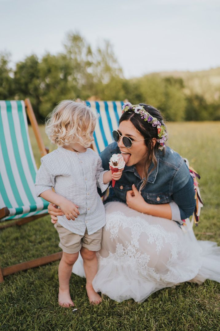 Little wedding guest with an ice cream cone lets mum/bride take a lick 