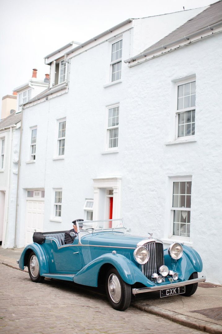 Classic blue roofless Rolls Royce wedding car