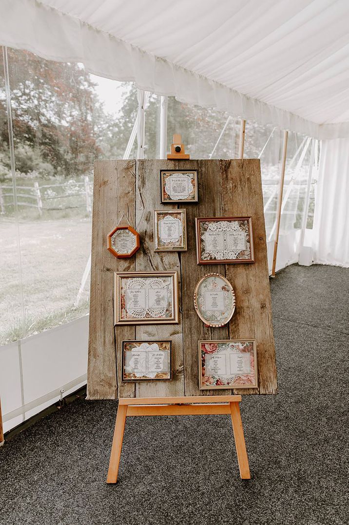 Mismatched photo frame table plan on wooden board with doilies 