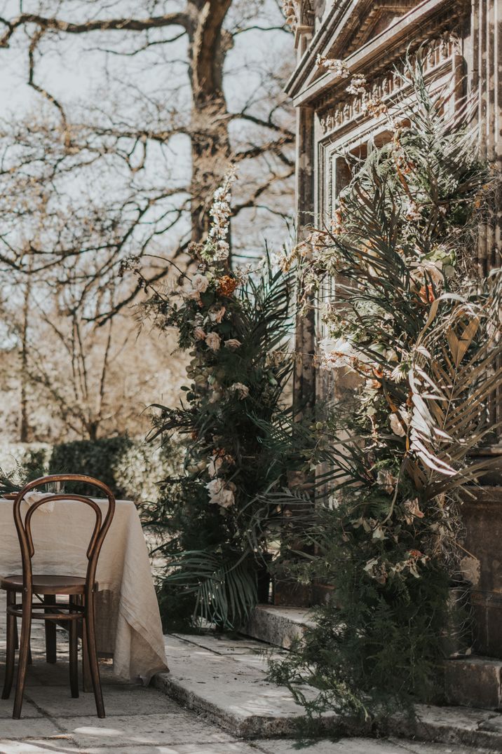 Neutral and natural wedding outdoor tablescape with coppery coloured chairs at Larmer Tree Gardens