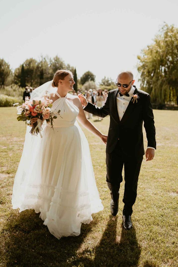 Bride in halterneck layered tulle wedding dress from Halfpenny London bridal boutique 