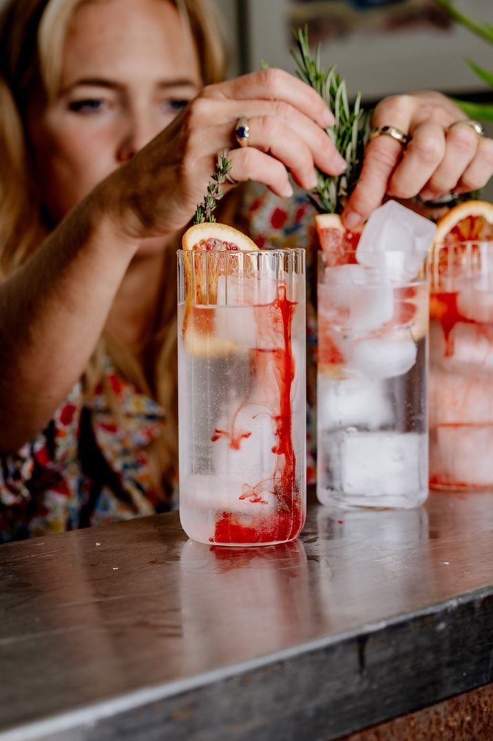 Mixologist adds garnishes to the wedding cocktails 