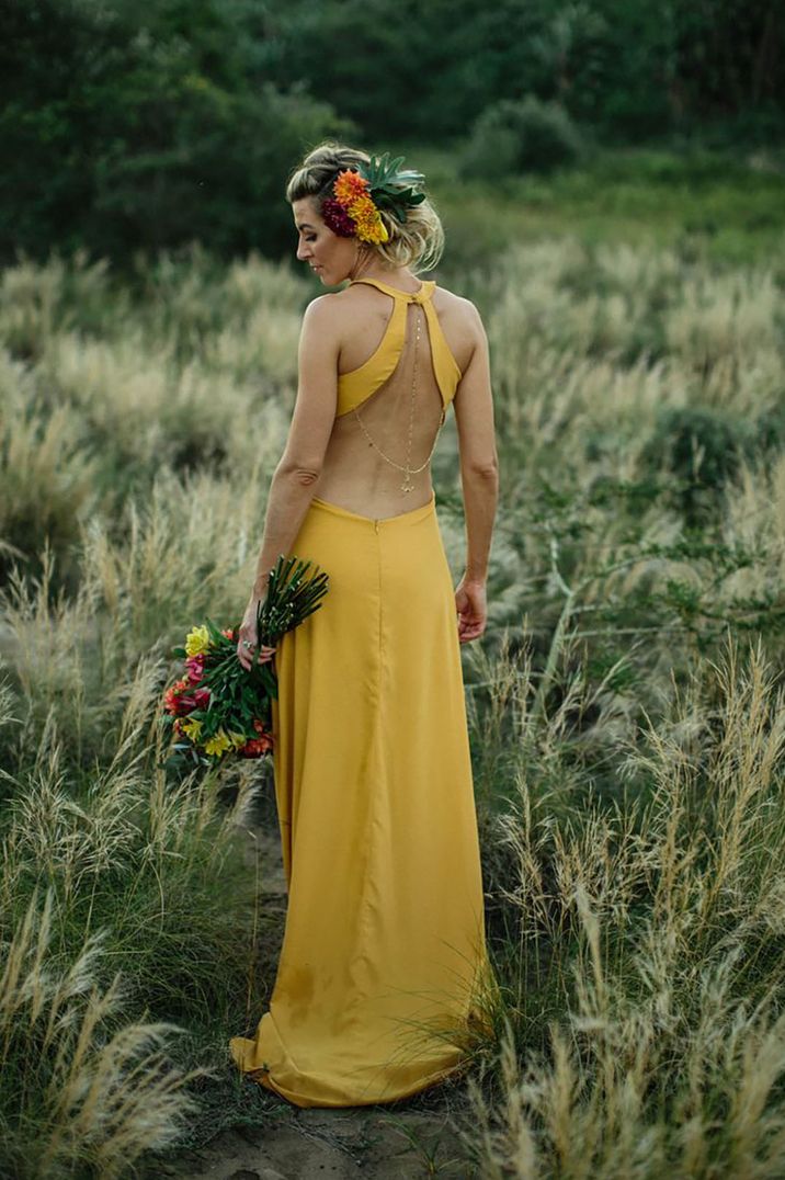 Bride in backless yellow wedding dress for tropical boho outdoor wedding 