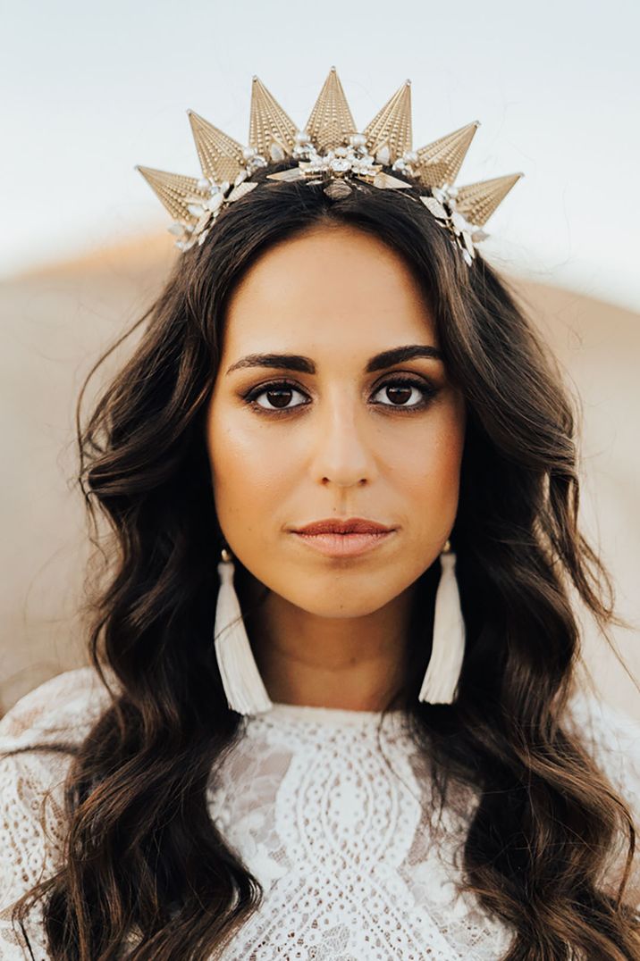 Bride wears statement gold head crown 