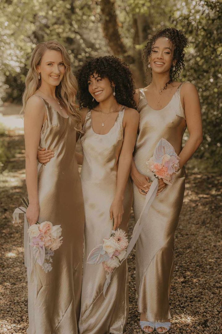 Bridesmaids wearing slip satin gold bridesmaid dresses - hen party ideas